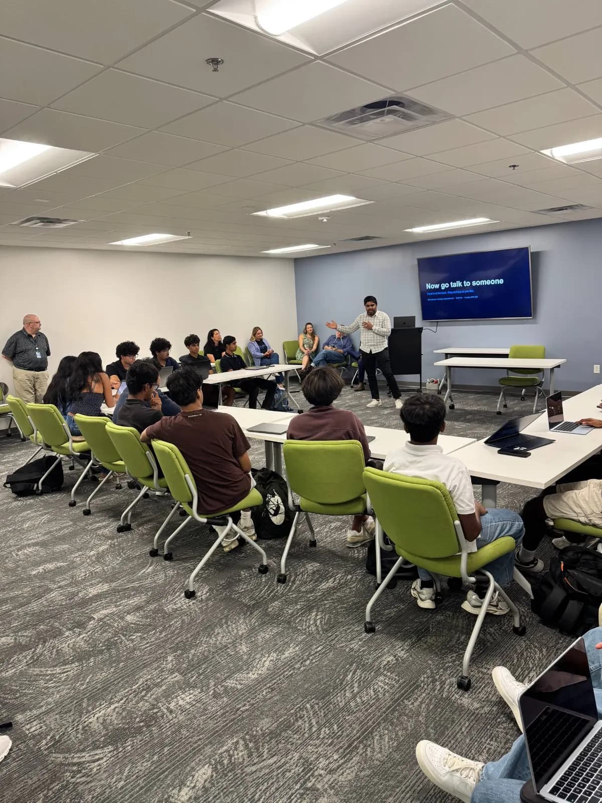 The room during the networking night, with the instruction on screen